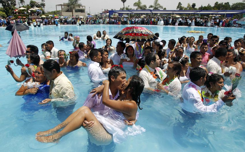 En Lima, decenas de parejas combatieron el calor con un húmedo matrimonio masivo. (Reuters)