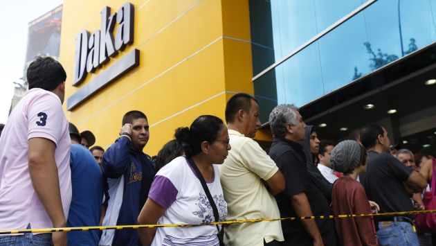 Los venezolanos hacen colas frente comercia}os ante saqueo legal dispuesto por el Gobierno. (Reuters)